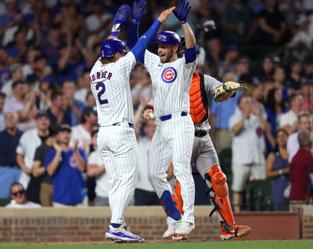 Chicago Cubs first baseman Michael Busch celebrates with Chicago Cubs second base Nico Hoerner (2), left, after hitting a two-run homer in the bottom of the sixth inning against the San Francisco Giants at Wrigley Field on June 17, 2024, in Chicago. (Stacey Wescott/Chicago Tribune)