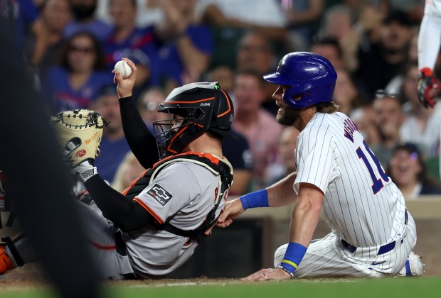 Chicago Cubs first base Patrick Wisdom (16) is tagged out by San Francisco Giants catcher Patrick Bailey (14) in the bottom of the 5th inning at Wrigley Field on June 17, 2024, in Chicago. (Stacey Wescott/Chicago Tribune)