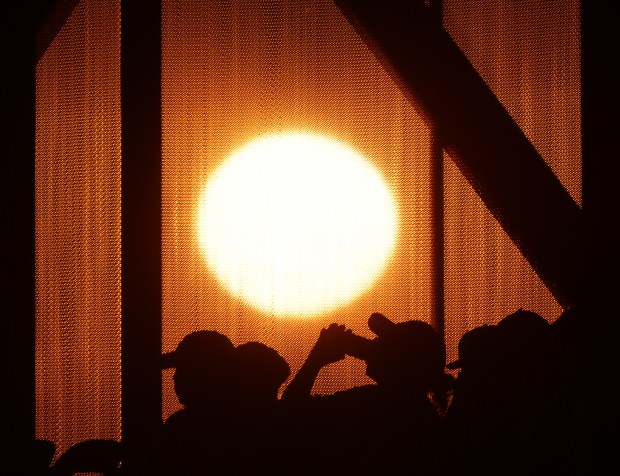 A fan in the 500 section drinks beer as the sun falls on the horizon in the sixth inning between the White Sox and Dodgers at Guaranteed Rate Field on June 26, 2024. (John J. Kim/Chicago Tribune)