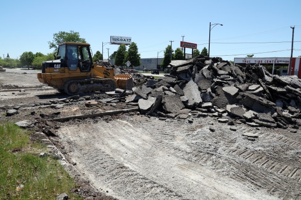 A worker removes asphalt from a piece of land on South Corliss Avenue near 111th Street in Chicago on May 30, 2024. A Chick-fil-A restaurant is slated to be built on the site.(Terrence Antonio James/Chicago Tribune)