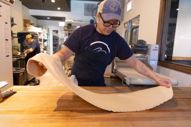 Sweet Rabbit Bakery owner Andrew Cheng prepares butter croissants on May 29, 2024, in Chicago. (Stacey Wescott/Chicago Tribune)