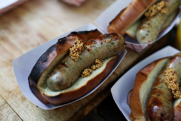 Le Bouchon's boudin blanc are ready to be served during a Sunday BBQ on the patio of Sportsman's Club in Ukrainian Village on June 2, 2024. (Eileen T. Meslar/Chicago Tribune)