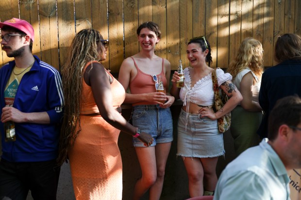 People attend a Sunday BBQ on the patio of Sportsman's Club in Ukrainian Village on June 2, 2024. (Eileen T. Meslar/Chicago Tribune)
