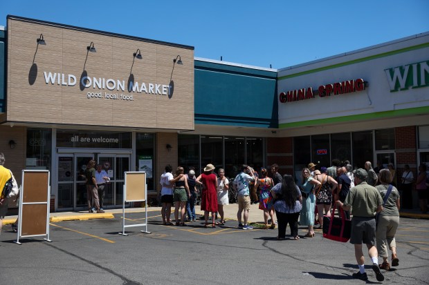 People gather before the grand opening of Wild Onion Market co-op in Rogers Park on June 12, 2024. (Eileen T. Meslar/Chicago Tribune)