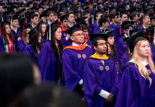 Graduates listen during Northwestern University's commencement on June 9, 2024, at the United Center. (Brian Cassella/Chicago Tribune)