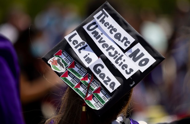 A message is displayed on a mortarboard as several dozen graduates and supporters gather outside after walking out in support of the Palestinians during Northwestern University's commencement on June 9, 2024, at the United Center. (Brian Cassella/Chicago Tribune)