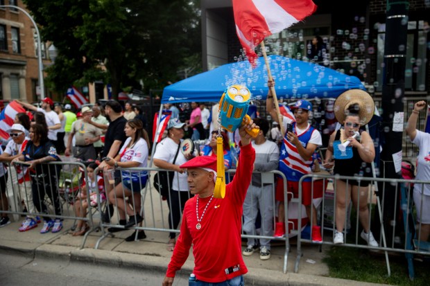 Davy Vasquez, a parade participant, waves a bubble wand during the 46th Puerto Rican People's Day Parade on on June 8, 2024, in Humboldt Park in Chicago. (Vincent Alban/Chicago Tribune)