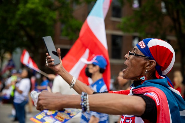 Margarita Lolis cheers during the 46th Puerto Rican People's Day Parade on June 8, 2024, in Humboldt Park in Chicago. (Vincent Alban/Chicago Tribune)