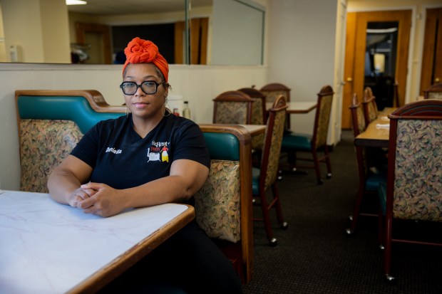 Daniella Coffey, the owner of St. Rest #2 Country Kitchen, sits in the seat her father would always sit in on June 7, 2024, at the restaurant in Chicago. (Vincent Alban/Chicago Tribune)