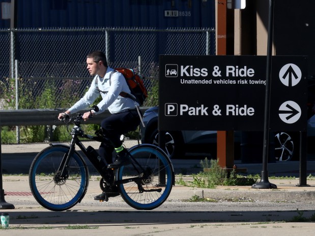 Dixon Galvez-Searle arrives on his bike at the Pulaski CTA Orange Line train station for a train ride to his job on June 11, 2024. Searle used to take a bus to the Orange Line but now bikes instead. (Antonio Perez/Chicago Tribune)