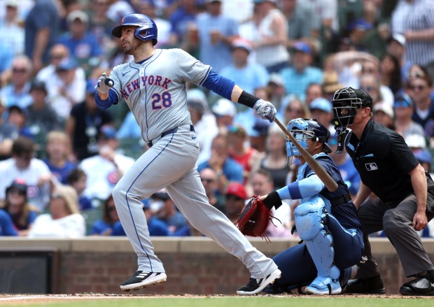 New York Mets designated hitter J.D. Martinez (28) follows through on his 3-run home run in the first inning of a game against the Chicago Cubs at Wrigley Field in Chicago on June 21, 2024. (Chris Sweda/Chicago Tribune)