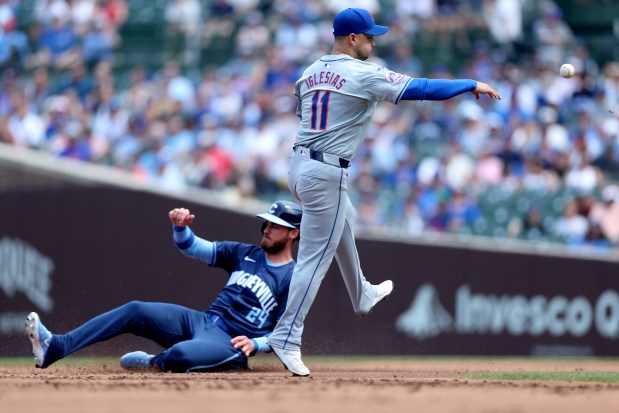Chicago Cubs center fielder Cody Bellinger (24) is forced out at second base as New York Mets second baseman Jose Iglesias (11) throws to first base as Cubs hitter Christopher Morel grounds into a double play in the first inning of a game at Wrigley Field in Chicago on June 21, 2024. (Chris Sweda/Chicago Tribune)