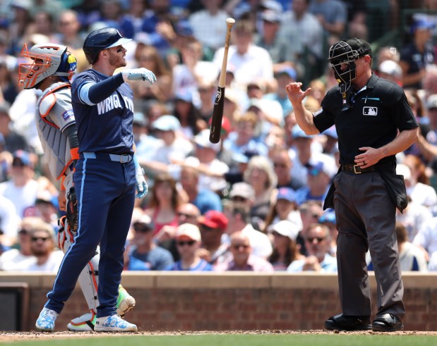 Chicago Cubs left fielder Ian Happ (8) tosses hit bat aside after striking out to end the first inning of a game against the New York Mets at Wrigley Field in Chicago on June 21, 2024. (Chris Sweda/Chicago Tribune)