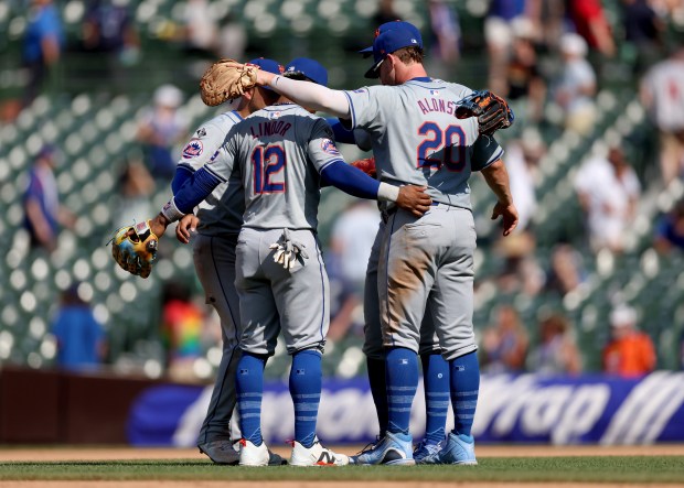 The New York Mets, including Francisco Lindor (12) and Pete Alonso (20), celebrate after a victory over the Chicago Cubs at Wrigley Field in Chicago on June 21, 2024. (Chris Sweda/Chicago Tribune)