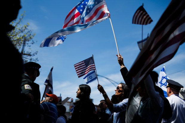 Pro-Israel activists argue with pro-Palestinian activists while members of the Chicago Police department stand between the two groups outside a pro-Palestinian encampment at DePaul University on May 5, 2024, in Chicago. (Armando L. Sanchez/Chicago Tribune)