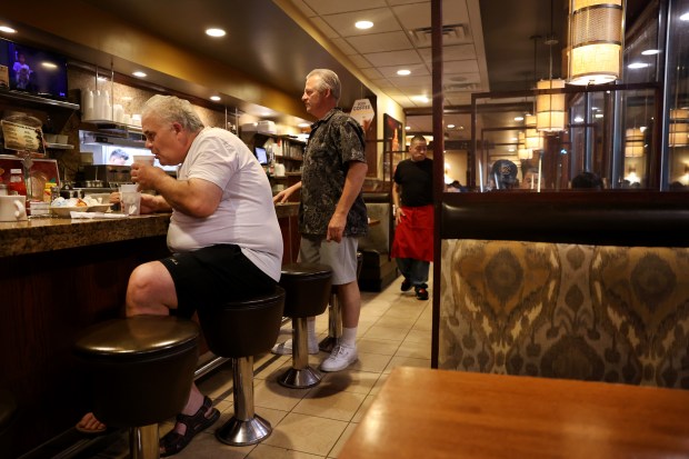 Frank Tripkovich sips coffee at 10:35 p.m. at the Golden Apple on June 22, 2024. (Chris Sweda/Chicago Tribune)