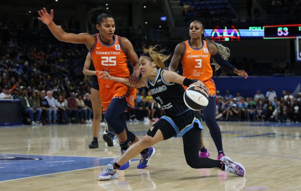 Sky guard Chennedy Carter puts a move on Sun forward Alyssa Thomas in the second half at Wintrust Arena in Chicago on June 12, 2024. (Chris Sweda/Chicago Tribune)