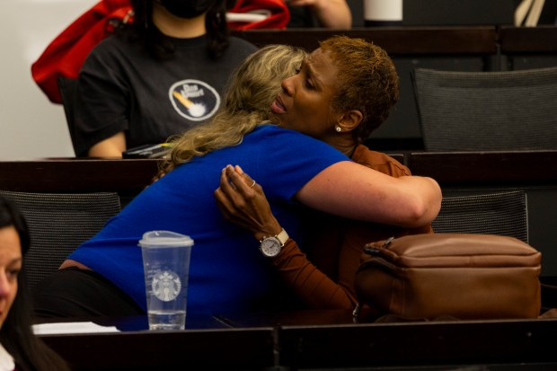 Shawn Hardy Hatchett, right, the partner to Michael Broadway, hugs Terah Tollner, an attorney with Kaplan and Grady, who represents Michael Broadway's family, during a town hall meeting to discuss the poor conditions at Stateville Correctional Center on June 25, 2024, at the Northwestern University Pritzker School of Law in Chicago. The meeting was prompted by the death of Michael Broadway, allegedly caused by high heat and poor ventilation at the prison. Broadway, who was 51, was a graduate of the Northwestern Prison Education Program. (Vincent Alban/Chicago Tribune)