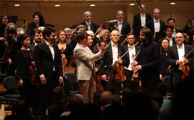 Piano soloist Daniil Trifonov, right, receives applause from former CSO composer-in-residence Mason Bates, center, as guest conductor Lahav Shani looks on at Symphony Center on June 20, 2024. (Chris Sweda/Chicago Tribune)