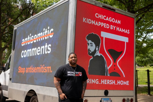 Jeremiah Smith poses for a portrait with his truck that has digital screens meant to raise awareness for Israelis taken hostage by Hamas on Oct. 7, 2023, on May 31, 2024, near Mary Bartelme Park in Chicago. (Vincent Alban/Chicago Tribune)