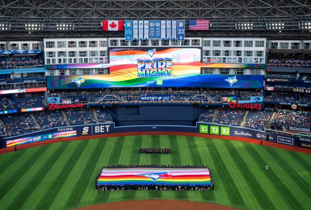 A Pride themed flag is displayed in the outfield at the Rogers Centre on June 14, 2024 in Toronto. (Photo by Mark Blinch/Getty Images)