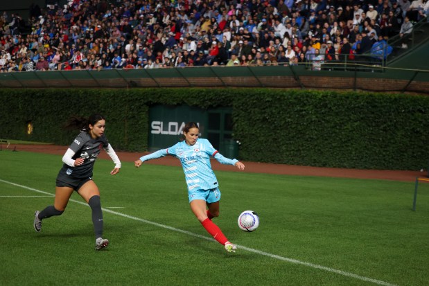 Red Stars midfielder Shea Groom tries to get the ball away from Bay FC's Scarlett Camberos on June 8, 2024, at Wrigley Field. (Eileen T. Meslar/Chicago Tribune)