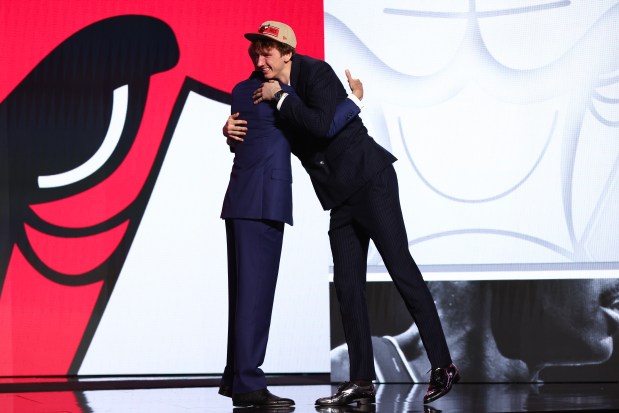 Matas Buzelis (R) hugs NBA commissioner Adam Silver (L) after being drafted 11th overall by the Chicago Bulls during the first round of the 2024 NBA Draft at Barclays Center on June 26, 2024 in the Brooklyn borough of New York City. NOTE TO USER: User expressly acknowledges and agrees that, by downloading and or using this photograph, User is consenting to the terms and conditions of the Getty Images License Agreement. (Photo by Sarah Stier/Getty Images)