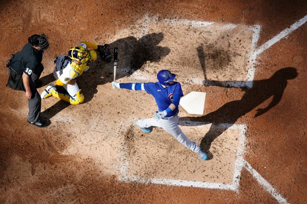 Cubs left fielder Ian Happ, right, hits a tiebreaking two-run home run during the eighth inning against the Brewers on June 29, 2024, in Milwaukee. (Aaron Gash/AP)
