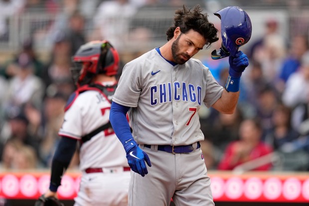 Chicago Cubs' Dansby Swanson (7) reacts after striking out during the fifth inning of a baseball game against the Minnesota Twins, Saturday, May 13, 2023, in Minneapolis. (AP Photo/Abbie Parr)