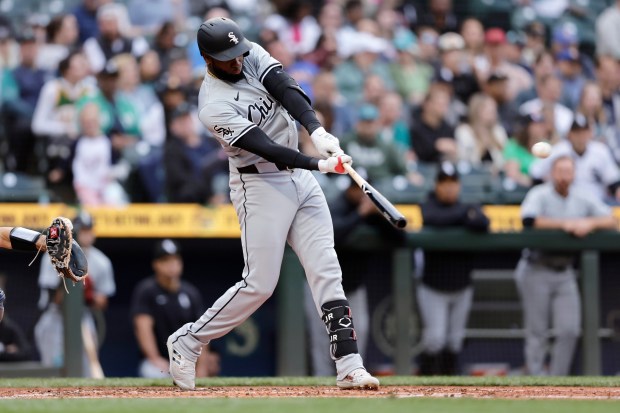 White Sox center fielder Luis Robert Jr. hits a solo home run during the third inning on June 13, 2024, in Seattle. (John Froschauer/AP)