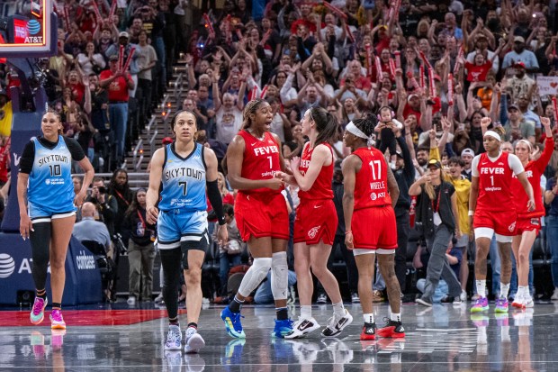 Indiana Fever players celebrate after defeating Chicago Sky during a WNBA basketball game Saturday, June 1, 2024, in Indianapolis. (AP Photo/Doug McSchooler)