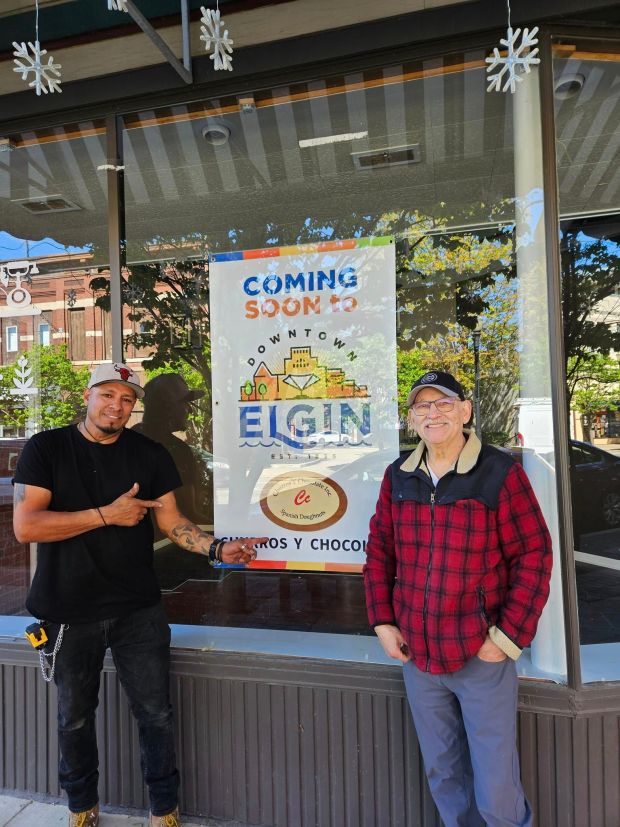 The owners of the new Churros y Chocolate shop stand in front of their 66 S. Grove Ave. storefront in downtown Elgin that will be opening later this summer. (Downtown Neighborhood Association of Elgin)