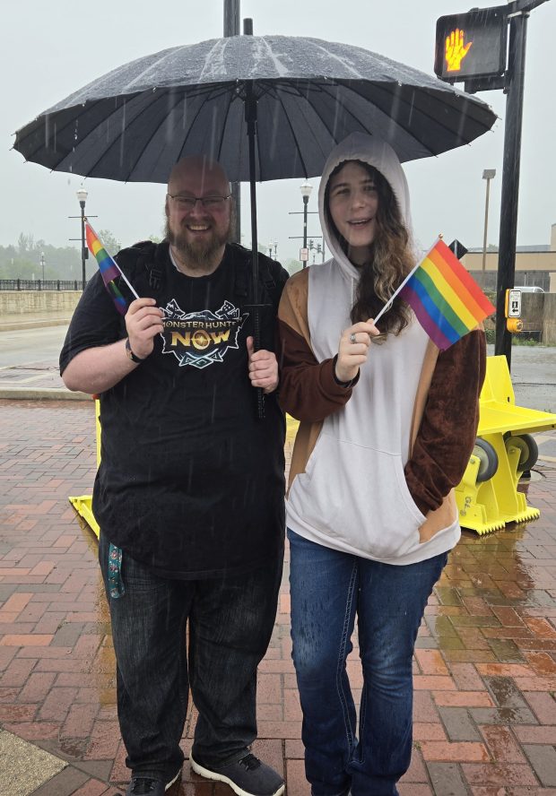 Christina Heald and her boyfriend, David Smalec, visiting the area from Texarkana, Texas, said they wouldn't let a little rain Saturday stop them from attending the downtown Elgin Pride Parade. (Gloria Casas/The Courier-News)