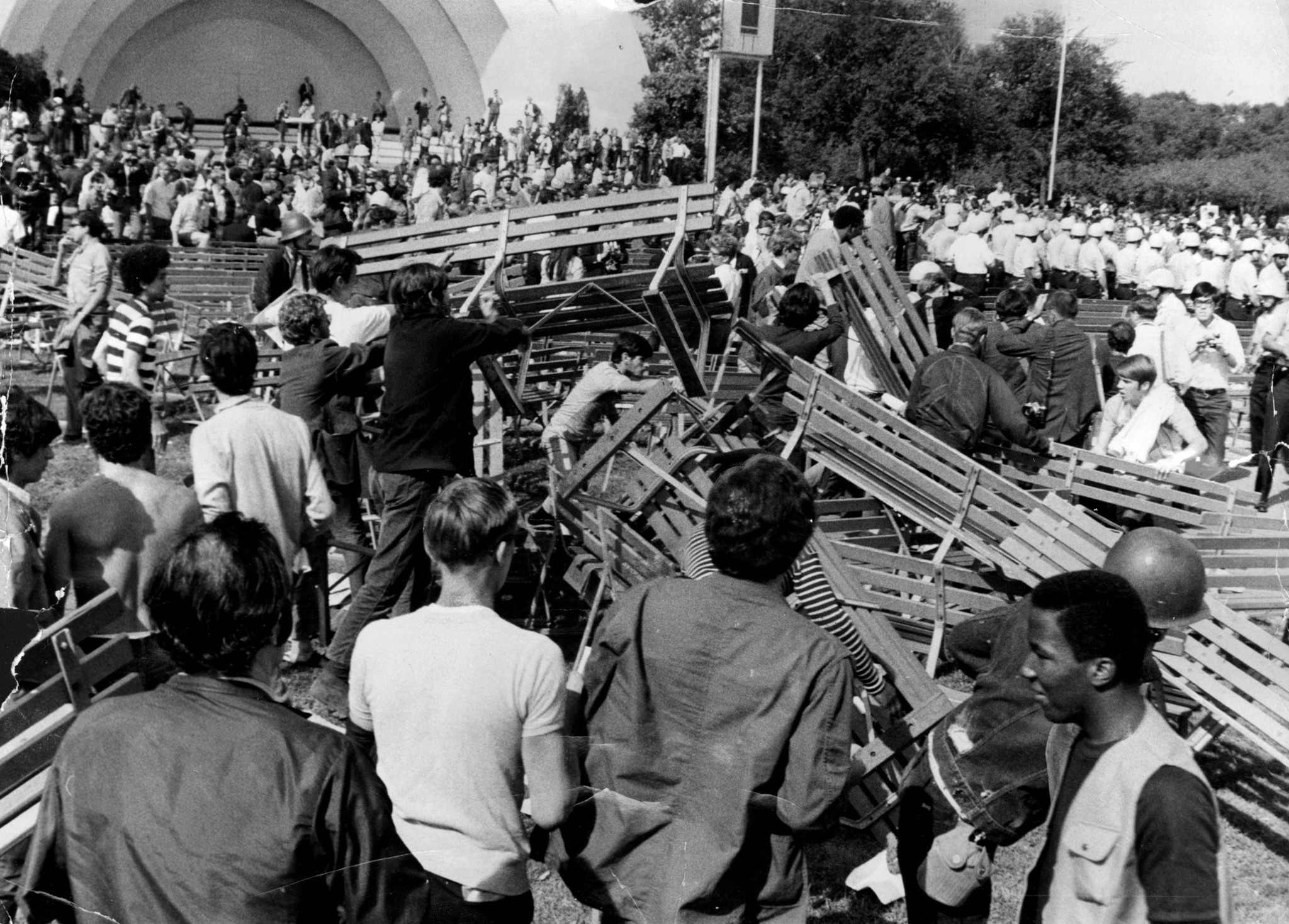 Anti-war demonstrators in Grant Park pile up benches as a...