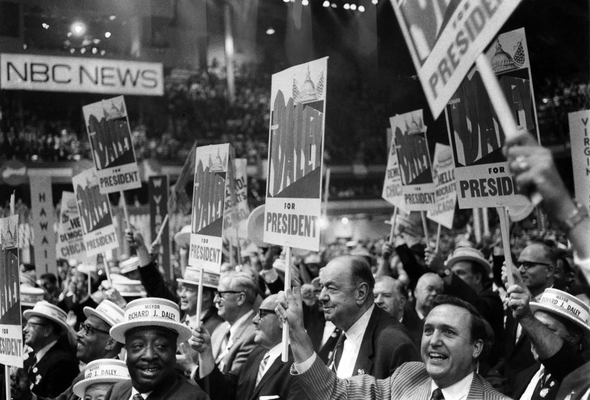 The Illinois delegation enters the convention hall floor holding Daley...