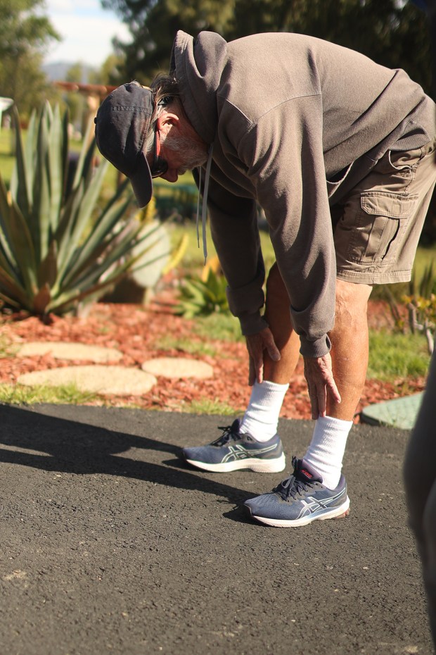 Ray Emmons gets in some morning stretches. (Michael Blackshire/Los Angeles Times/TNS)