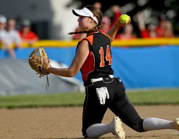 After knocking down a grounder bare handed, Libertyville's Zoe Kinsella (14) choses not to throw out any runners. Mundelein defeated Libertyville 5-1 in the softball Class 4A Warren Sectional championship game, Friday, May 31, 2024 in Lincolnshire. (Rob Dicker/for the Lake New-Sun)