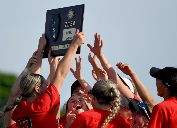 Mundelein players celebrate with the sectional championship trophy. Mundelein defeated Libertyville 5-1 in the softball Class 4A Warren Sectional championship game, Friday, May 31, 2024 in Lincolnshire. (Rob Dicker/for the Lake New-Sun)