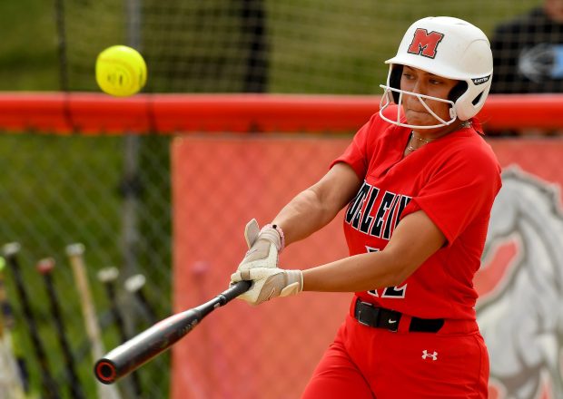 Mundelein's Karina Benes (12) hits the ball, scoring Kieley Tomas (2) from second, the first run of the game. Mundelein's softball team defeated Prospect 5-0 in the Class 4A Mundelein Regional championship game title at Mundelein, Friday May 24, 2024. (Rob Dicker/for the Lake New-Sun)