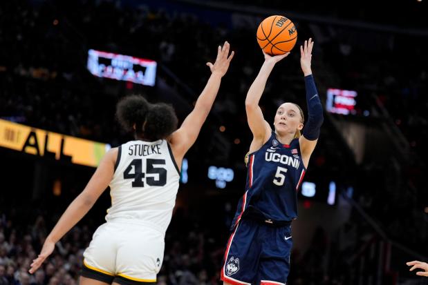 UConn guard Paige Bueckers (5) shoots over Iowa forward Hannah Stuelke (45) during the first half of a Final Four game in the NCAA Tournament on April 5, 2024, in Cleveland. (Morry Gash/AP)