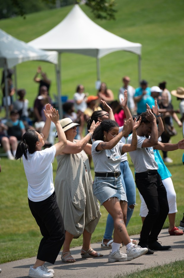 People dance to the music at last year's Juneteenth festival in Naperville's Rotary Park. The event returns to the same location Saturday, with plenty of food, music and other entertainment. (Naperville Neighbors United)