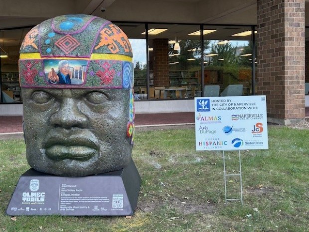 A sculpture inspired by the colossal stone heads crafted by the early Meso-American Olmec civilization sits outside Naperville's Nichols Library at 200 W. Jefferson Ave. The sculpture, painted by artist Juan Aguilar Santis Chawuk, is part of a countywide outdoor exhibit called, "Olmec Trails: Culture and Legacy." (Courtesy city of Naperville)