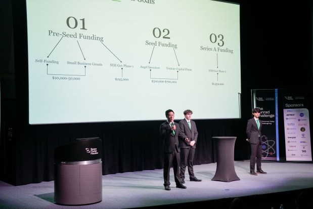 Naperville Central High School students Eddy Zhang and Andrew Bukowski and Naperville North High School student Ben Zhang pitch their business idea for the SmartSeat at the Conrad Challenge, a global STEM innovation and entrepreneurship competition. They were named the Pete Conrad Scholar winners in the health and nutrition category. (Johnson Space Center)