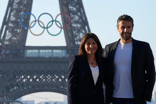 Paris mayor Anne Hidalgo and head of Paris 2024 Olympics pose in front of the Eiffel Tower Friday, June 7, 2024 in Paris. (AP Photo/Michel Euler)