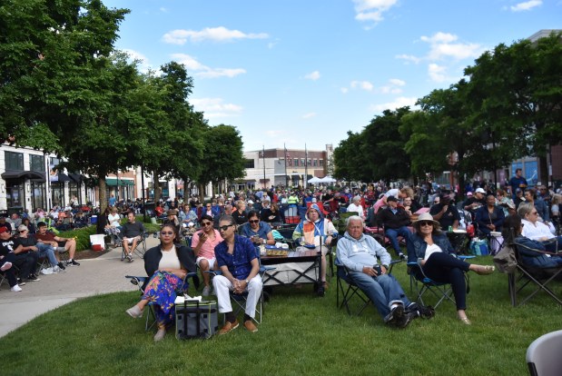 Filled to capacity, fans of live music sit on the village green for the Concerts on the Green Thursday. (Jesse Wright for the Pioneer Press)