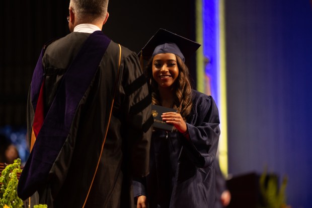 Glenbrook South graduate Hazel Ford receives her diploma during the school's graduation ceremony at Rosemont Theatre on Sunday, June 2, 2024. (Troy Stolt/for the Pioneer Press)