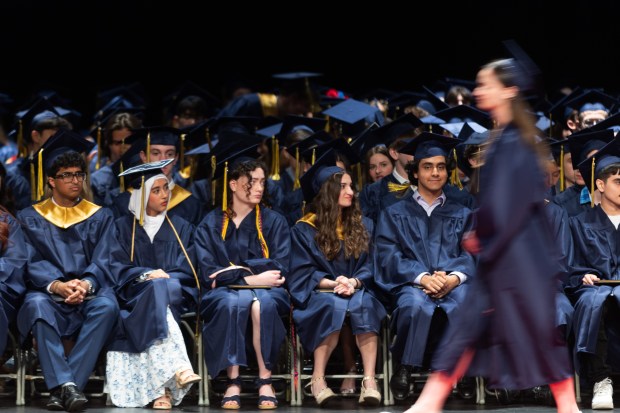 Members of the Glenbrook South Class of 2024 watch their classmates as they receive diplomas during the school's graduation ceremony at Rosemont Theatre on Sunday, June 2, 2024. (Troy Stolt/for the Pioneer Press)