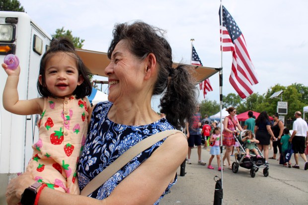Juliet Roy 18-month-old, from Glenview with her grandmother, Yen Lee during Glenview Summer Fest 2024 on Saturday. (Gina Grillo for the Pioneer Press)