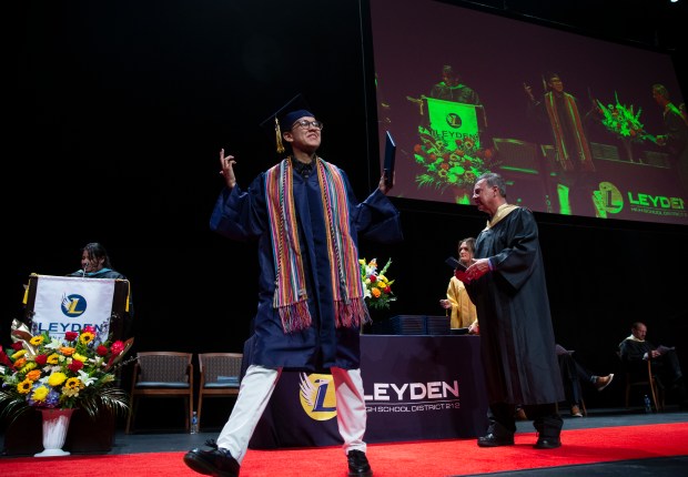 A student accepts his diploma during the East Lyden High School graduation ceremony at the Rosemont Theatre on Tuesday, May 21, 2024 in Rosemont, Illinois. ( John Konstantaras-Pioneer-Press ) - PPN-L-fhj-leyden-east-graduation 00077682A