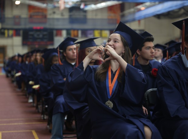 Maggie O'hara Kelley makes a heart sign towards the audience during the Class of 2024 graduation at Oak Park River Forest High School in Oak Park on Sunday, May 26, 2024. (Trent Sprague/for the Pioneer Press)